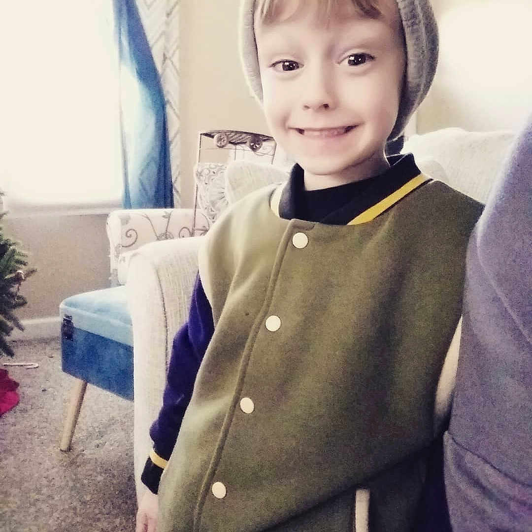 Ayden is registered to the contest to win money with this photo: boy, child, cool, day, girl, joy, neck, outerwear, person, product, skin, sleeve, smile, sweater, textile, toddler, top