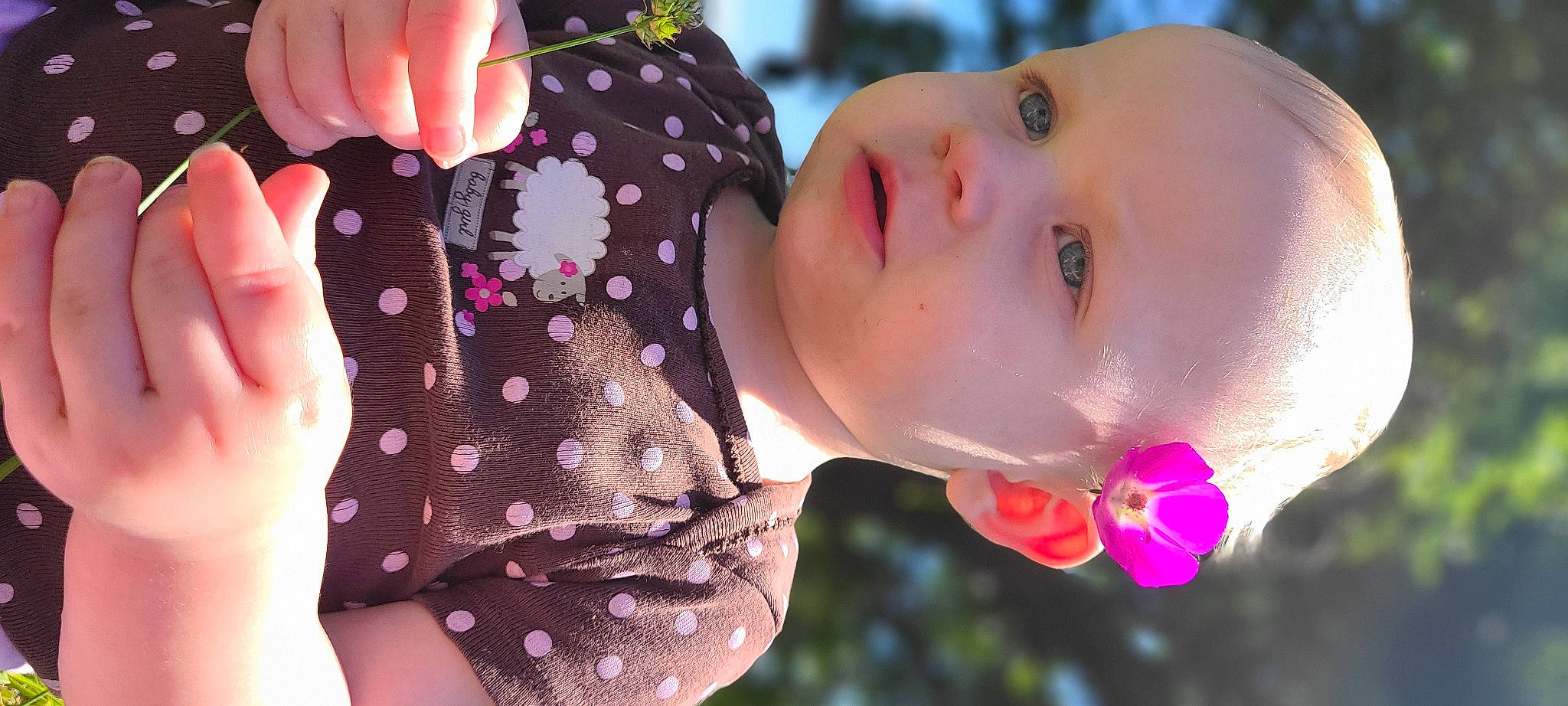 Kelly joined the competition — help win amazing prizes! baby, beauty, child, close_up, eye, eyelash, gesture, grass, happy, headgear, lip, nail, nose, people_in_nature, person, petal, pink, plant, skin, textile