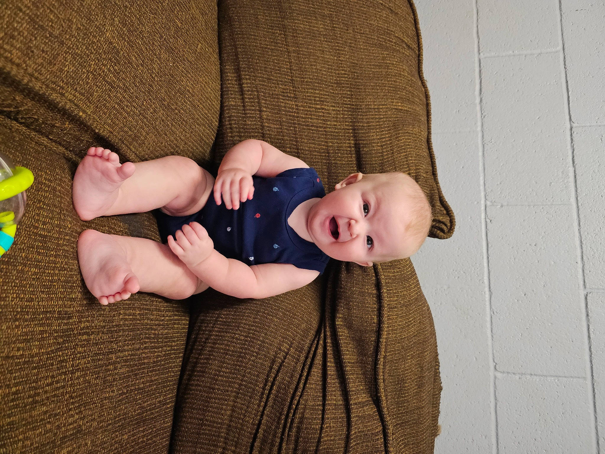 Maverick joined the competition — help win amazing prizes! baby, baby_toddler_clothing, child, comfort, finger, flooring, foot, grass, headgear, human_leg, knee, linens, pattern, person, sitting, skin, sleeve, sock, thigh, toddler