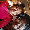 woman, girl, child, smiling, selfie, glasses, restaurant, wooden_chairs, wooden_tables, indoor, casual, happy, family, people, portrait, seated, african_american, hair, clothing, friendship
