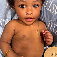 Eastyn is registered to the contest to win money with this photo: baby, bed, belly, big_eyes, blanket, bracelet, brown_skin, child, close_up, cute, dark_hair, hand, infant, jeans, month_marker, necklace, open_mouth, portrait, shirtless, wooden_sign