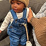 Eastyn is registered to the contest to win money with this photo: baby, beanie, blanket, child, couch, cute, denim_overalls, hand, indoors, infant, knit_hat, overalls, pacifier, pacifier_clip, plush_slippers, portrait, sitting, sofa, tattoo, teddy_slippers