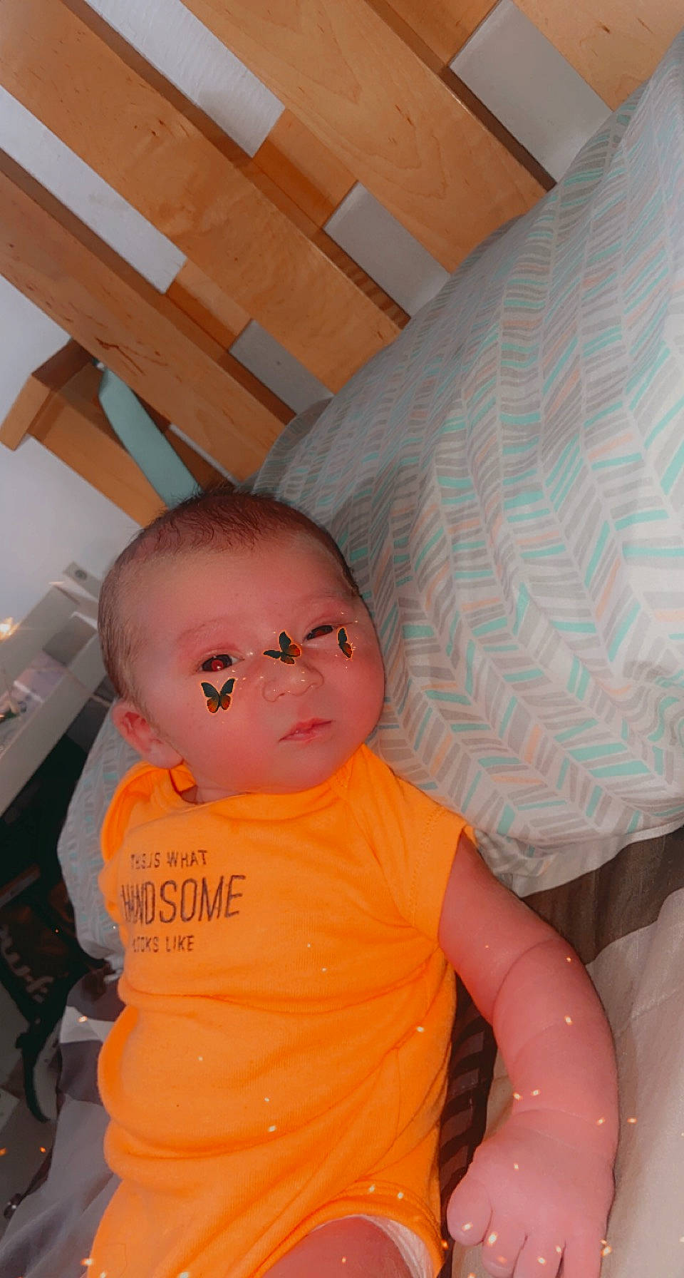 Maverick is registered to the contest to win money with this photo: abdomen, baby, baby_toddler_clothing, chair, cheek, child, comfort, eye, flooring, fun, hardwood, mouth, peach, person, room, sitting, skin, stomach, t_shirt, toddler