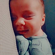 Daniel joined the competition — help win amazing prizes! baby, sleeping, smiling, pajamas, infant, face, child, cozy, cute, closeup, person, resting, peaceful, indoors, portrait, newborn, soft_light, expression, head, comfort