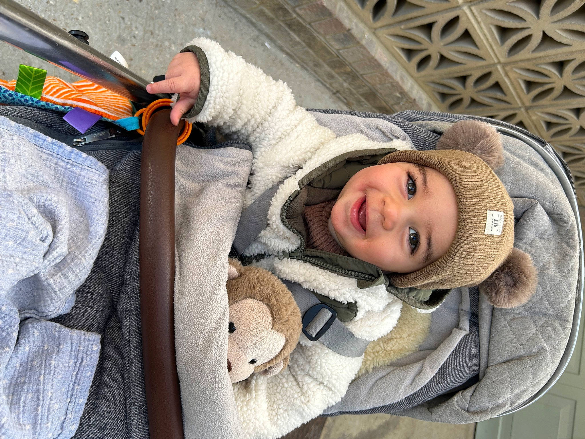 Leo is registered to the contest to win money with this photo: baby, baby_products, child, comfort, denim, eye, face, fun, fur, happy, headwear, hoodie, joy, outerwear, person, smile, textile, toddler, travel, tree