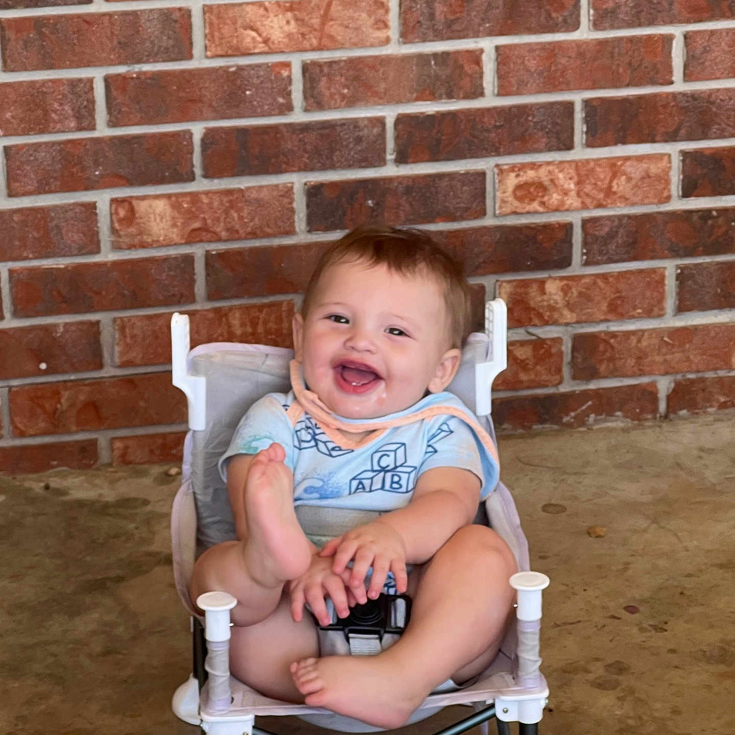 Abel joined the competition — help win amazing prizes! baby, child, smiling, barefoot, sitting, chair, brick_wall, happy, infant, casual, indoor, cute, playful, young_child, clothing, person, face, legs, feet, joy