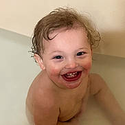Abel joined the competition — help win amazing prizes! toddler, child, bath, water, smile, happy, wet_hair, skin, face, curly_hair, rosy_cheeks, sitting, indoor, young_child, infant, cute, joyful, playful, bath_time, naked
