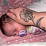 Scarlett is registered to the contest to win money with this photo: baby, sleeping, pacifier, hand, tattoo, flower_tattoo, pink, polka_dots, bedding, infant, newborn, peaceful, resting, close_up, skin, person, bed, blanket, soft, cute