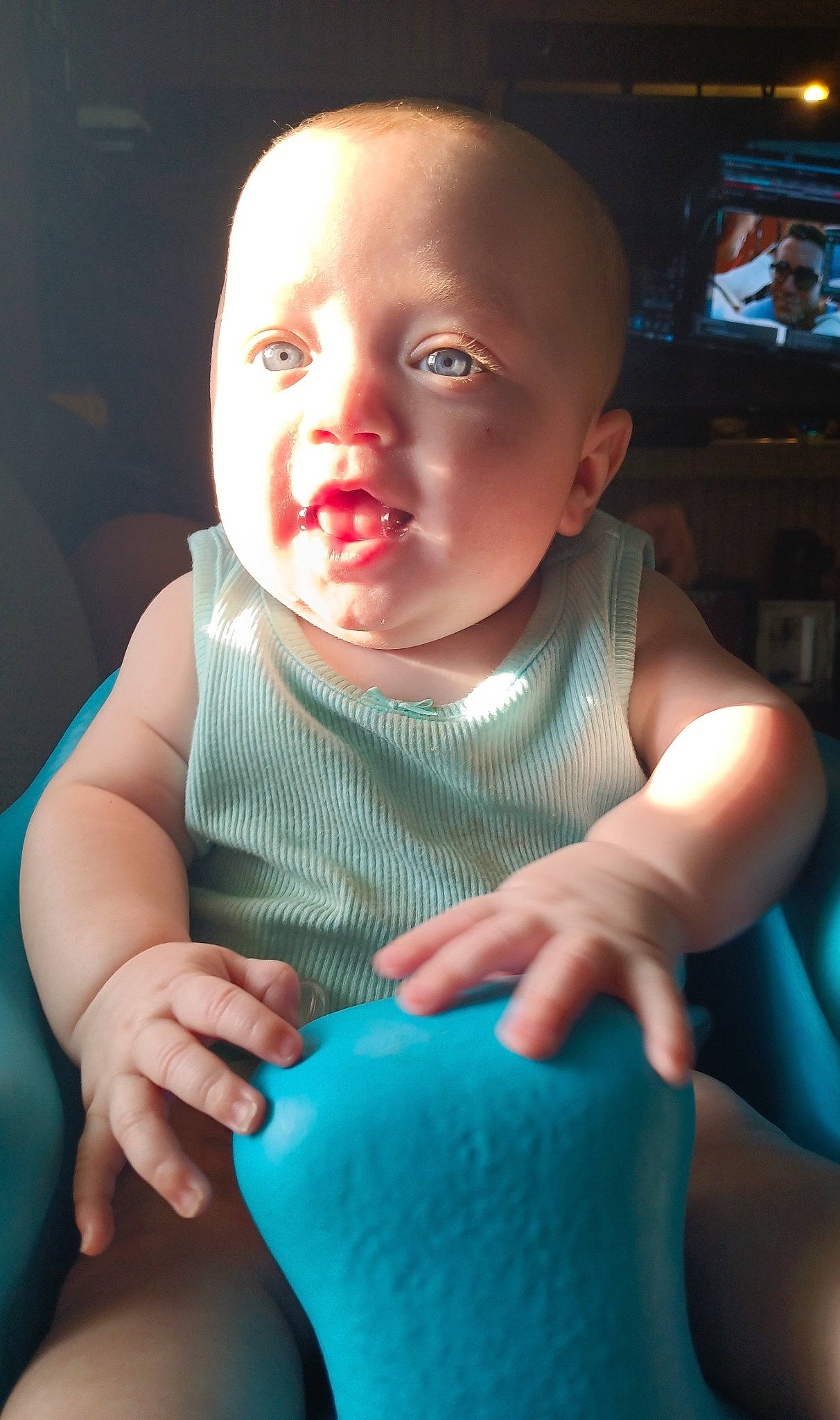 Sayla is registered to the contest to win money with this photo: arm, baby, baby_toddler_clothing, cheek, facial_expression, finger, flash_photography, gesture, hairstyle, happy, head, iris, mouth, nose, person, product, skin, sleeve, standing, television