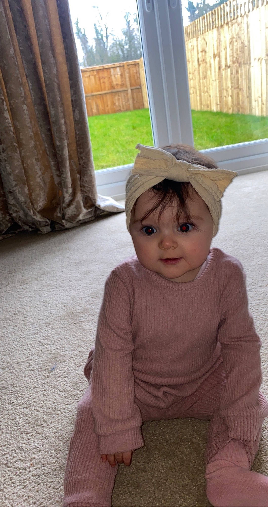 Evelyn joined the competition — help win amazing prizes! baby, baby_toddler_clothing, cap, cheek, child, curtain, fashion_accessory, fun, grass, hat, person, plant, sitting, skin, sleeve, smile, standing, tints_and_shades, toddler, window