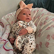 Ivory joined the competition — help win amazing prizes! baby, infant, headband, bow, blanket, pillow, onesie, floral_pattern, pink, cheeks, eyes, hand, face, awake, cozy, nursery, soft_texture, portrait, bedding, indoors