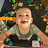 Elijah joined the competition — help win amazing prizes! baby, smiling, toys, playmat, colorful, infant, happy, child, indoor, cute, looking_up, clothing, playpen, hand, face, expression, young_child, baby_toys, cheerful, portrait