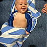 Elijah joined the competition — help win amazing prizes! baby, child, towel, blue, striped, smiling, happy, couch, fabric, hands, skin, indoor, portrait, young, infant, cute, sitting, comfortable, human, warm