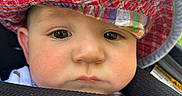 Elijah is registered to the contest to win money with this photo: baby, casual, cheeks, child, closeup, colorful_hat, cute, expression, face, hat, headwear, infant, natural_light, outdoor, person, portrait, skin, summer, texture, young_child