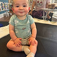 Elijah joined the competition — help win amazing prizes! baby, child, smiling, indoor, person, sitting, clothing, socks, table, drink, woman, face, cute, playful, cross_legged, light, casual, furniture, home, portrait