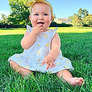 Willow joined the competition — help win amazing prizes! baby, child, grass, outdoor, greenery, sunlight, blue_sky, headband, dress, smiling, sitting, nature, summer, cute, happy, infant, person, portrait, trees, daylight