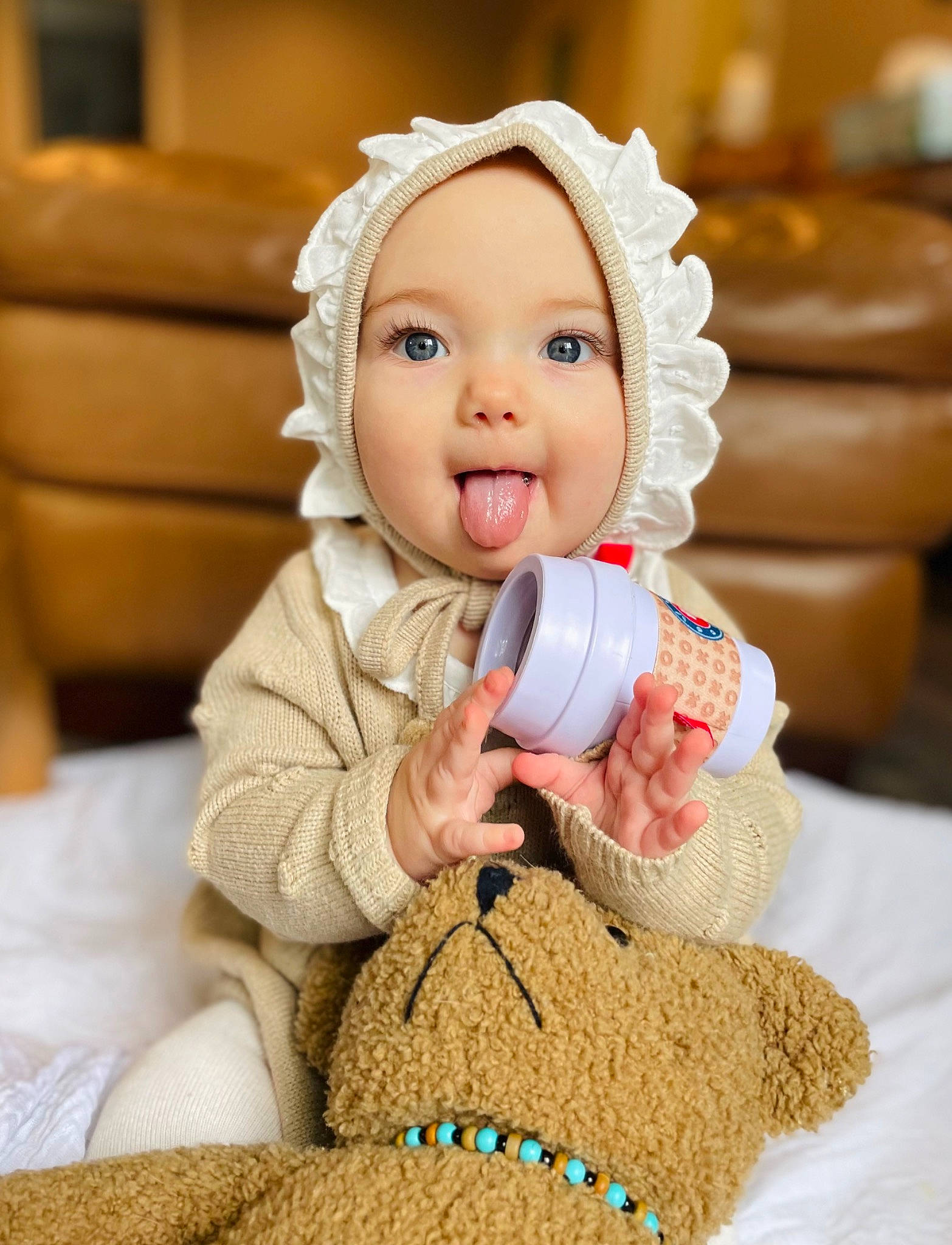 Ophelia is registered to the contest to win money with this photo: baby, baby_toddler_clothing, cheek, child, comfort, finger, flooring, fun, gesture, happy, headwear, person, pink, room, sitting, skin, sleeve, smile, surprise, thumb