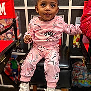 Jhayde joined the competition — help win amazing prizes! child, toddler, person, sitting, pink_outfit, dinosaur_print, hair_buns, big_eyes, white_sneakers, high_chair, indoor, portrait, cute, smile, hands, legs, closeup, bokeh, playful, chair