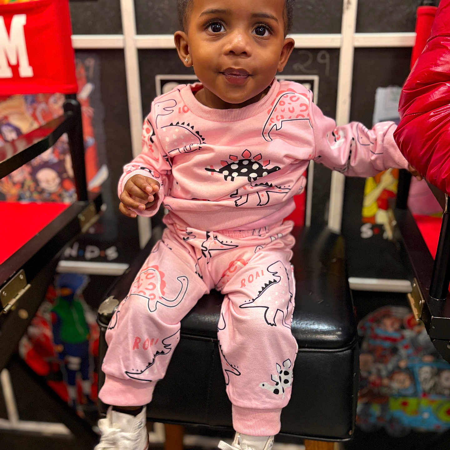 Jhayde joined the competition — help win amazing prizes! big_eyes, bokeh, chair, child, closeup, cute, dinosaur_print, hair_buns, hands, high_chair, indoor, legs, person, pink_outfit, playful, portrait, sitting, smile, toddler, white_sneakers