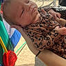 Ciara Mcguire joined the competition — help win amazing prizes! arms, baby, backyard, child, close_up, face, furniture, holding, infant, leopard_print, newborn, onesie, outdoor, patio, plastic_chair, play_structure, portrait, sleepy, sunlight, toy