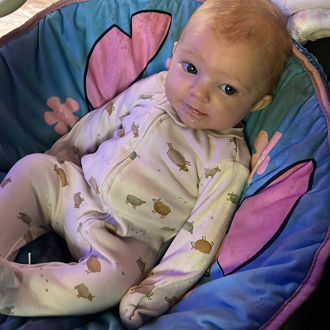 Ciara Mcguire is registered to the contest to win money with this photo: baby, baby_seat, blanket, bouncer, child, clothing, colorful, cute, eyes, face, furniture, home, indoor, infant, looking_at_camera, onesie, photography, portrait, relaxed, sitting