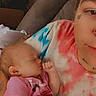 adult, baby, bed, blanket, child, close_up, cozy, cuddling, face, family, heart_doodle, indoor, infant, onesie, pink_clothing, portrait, selfie, sleeping, smile, tattoo