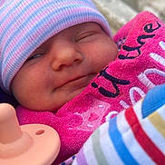 Ciara Mcguire joined the competition — help win amazing prizes! baby, beanie, blanket, bundled, chair, child, close_up, colorful, cute, face, hat, infant, newborn, outdoor, pacifier, pink, portrait, sleepy, smile, striped_clothing