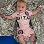 Maeve joined the competition — help win amazing prizes! baby, infant, foil_blanket, pink_clothing, sportswear, blue_background, face, arms, legs, curious_expression, lying_down, indoor, infant_bracelet, text_card, sensory_blanket, puma_logo, stockport_county_fc, soft_lighting, child, cute