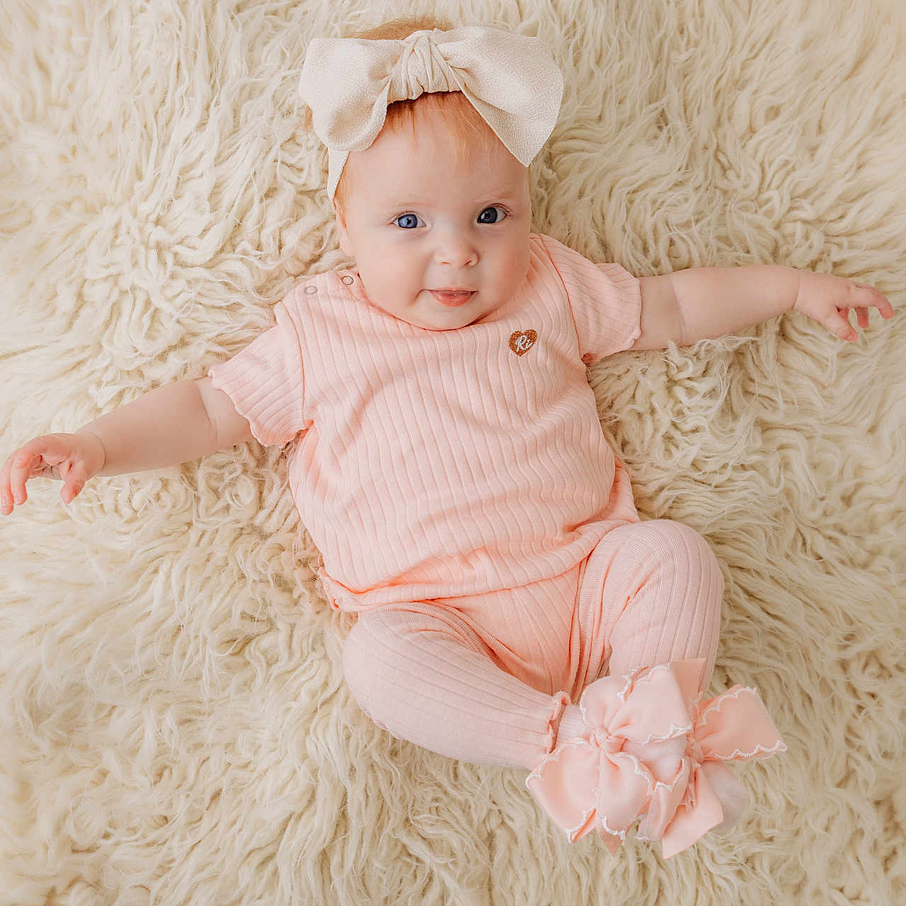 Maeve joined the competition — help win amazing prizes! adorable, baby, blue_eyes, bow, child, comfortable, cozy, cute, fashion, fluffy_rug, happy, headband, indoor, infant, lying_down, person, pink_clothing, portrait, smiling, soft_texture