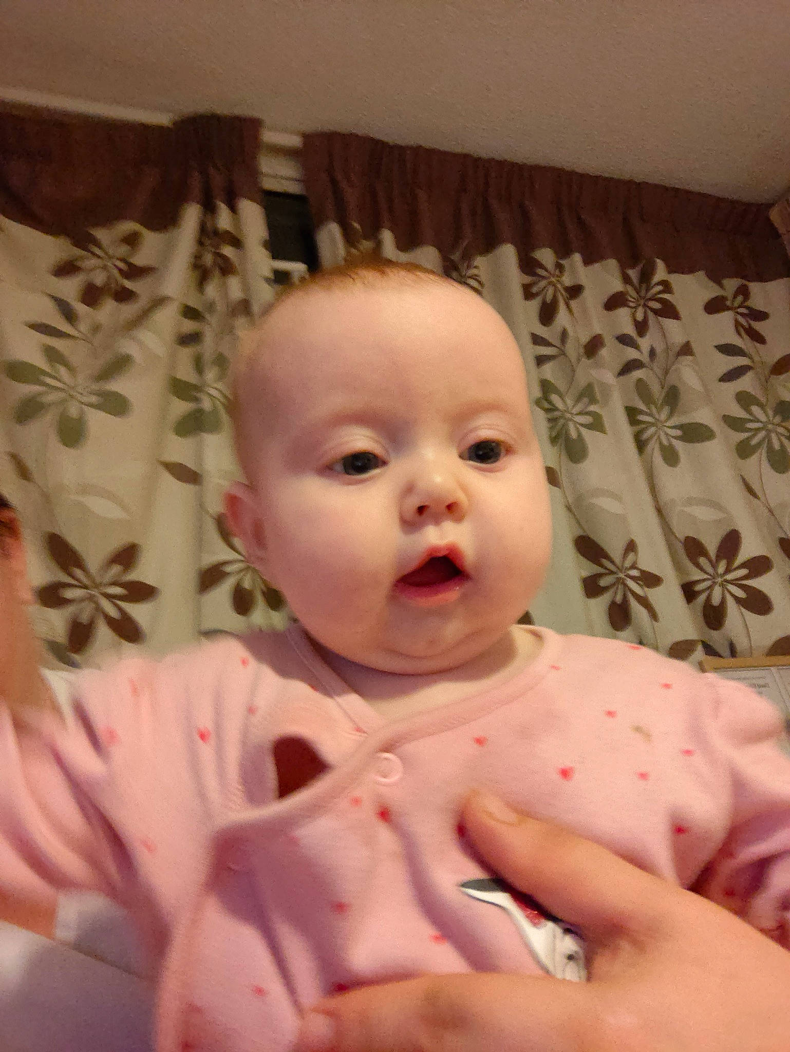 Darcie is registered to the contest to win money with this photo: baby, baby_toddler_clothing, cheek, chin, comfort, eye, eyebrow, face, finger, gesture, happy, head, human_body, iris, lip, mouth, nose, person, pink, skin