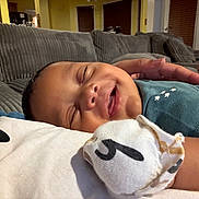 Michael joined the competition — help win amazing prizes! baby, sleeping, hand, blanket, couch, indoor, cozy, comfort, infant, child, soft, peaceful, relaxing, person, closeup, face, smile, home, toddler, rest