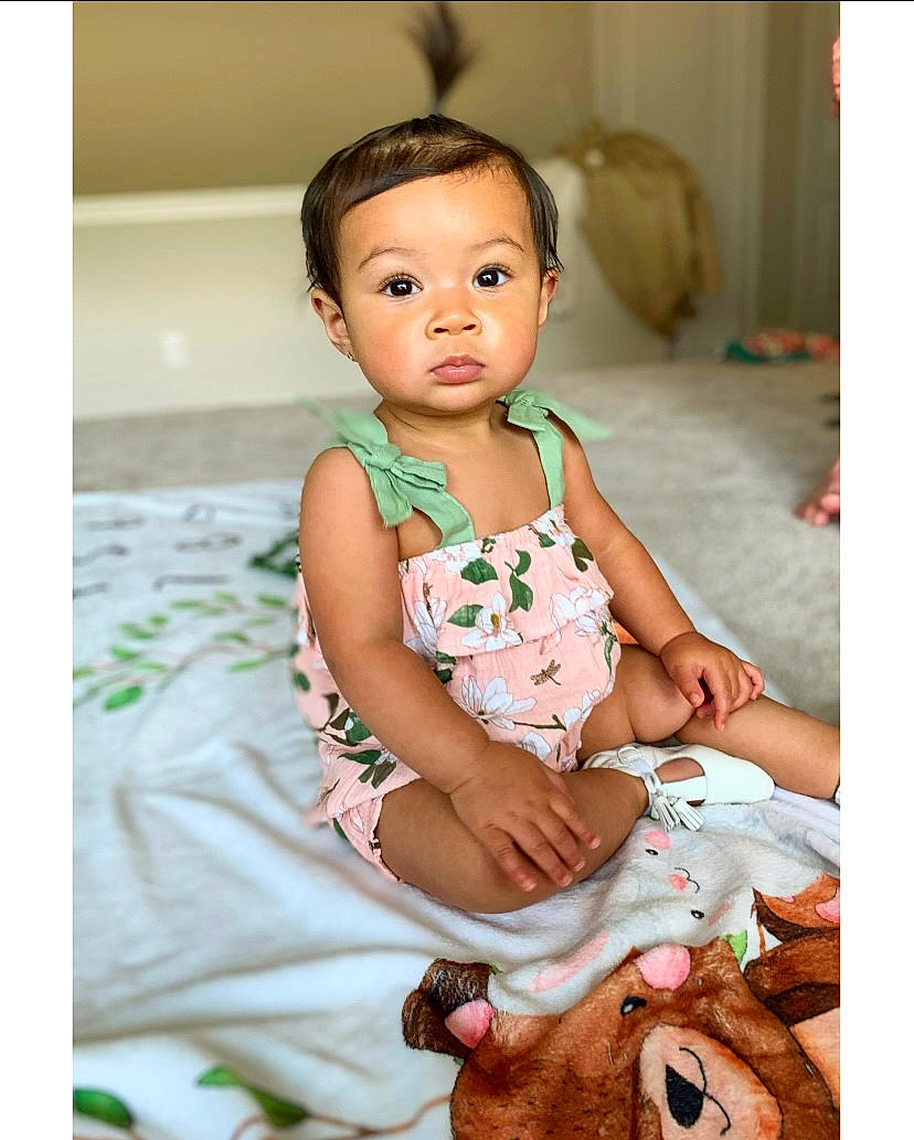 Brayleigh is registered to the contest to win money with this photo: baby, baby_toddler_clothing, cheek, child, child_model, day_dress, dress, flash_photography, formal_wear, happy, human_leg, iris, pattern, person, photo_shoot, portrait_photography, sitting, skin, sleeve, toddler