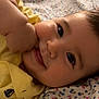 Leon joined the competition — help win amazing prizes! baby, child, smile, face, hand, yellow_shirt, blanket, floral_pattern, lying_down, close_up, cute, happy, indoors, skin, portrait, infant, young_child, soft_lighting, comfort, cozy