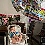 baby, high_chair, balloons, happy_birthday, smile, roses, bouquet, flowers, dining_table, chair, indoor, celebration, diaper, person, wood_floor, colorful, party, joyful, infant, room