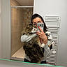 cat, woman, mirror, selfie, bathroom, phone, red_nails, gray_sweater, shower, tiles, long_hair, fluffy_cat, pet, indoor, reflection, holding, portrait, feline, cozy, home