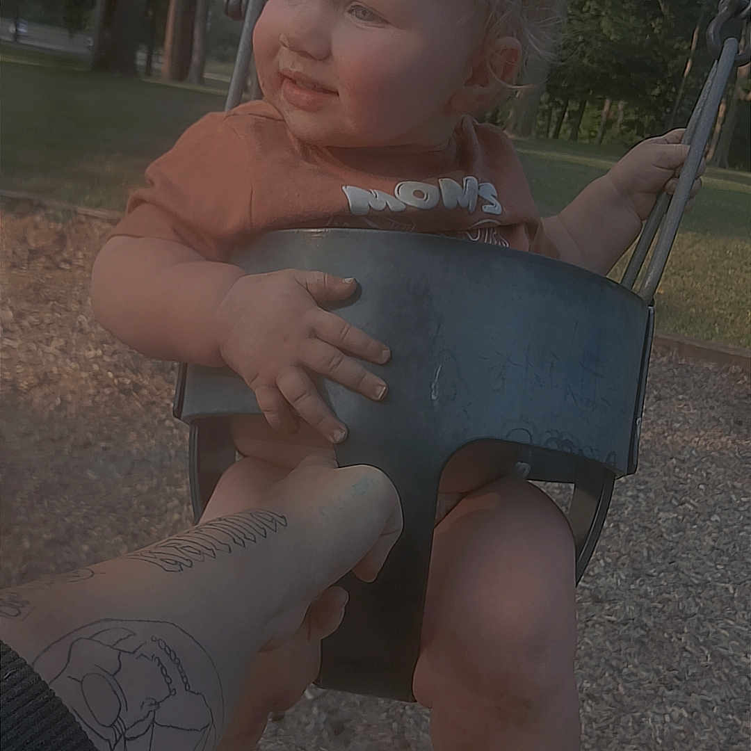 Aaxton joined the competition — help win amazing prizes! child, clothing, daylight, fun, grass, hand, happy, holding, nature, outdoor, park, person, playground, seat, smiling, swing, tattoo, toddler, tree, young