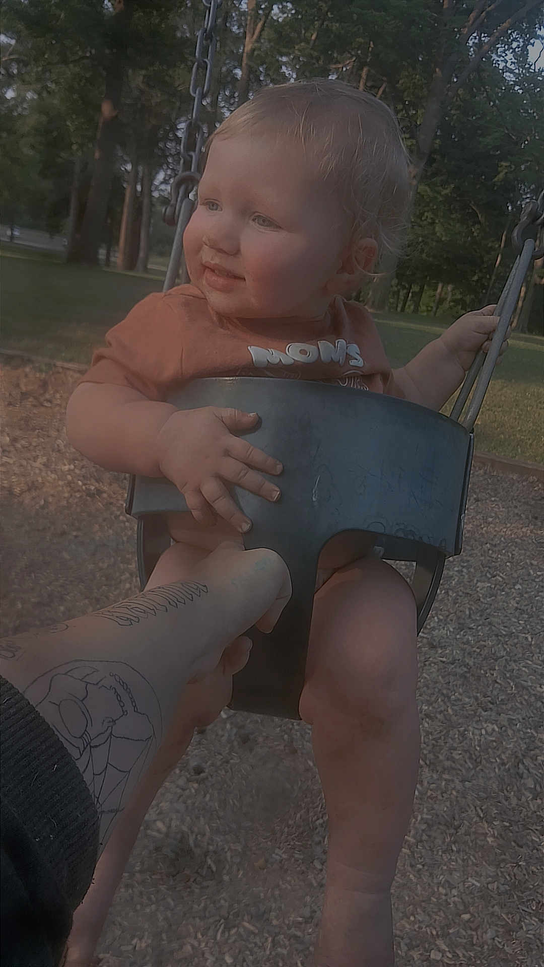 Aaxton joined the competition — help win amazing prizes! child, clothing, daylight, fun, grass, hand, happy, holding, nature, outdoor, park, person, playground, seat, smiling, swing, tattoo, toddler, tree, young