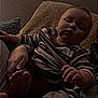 Aaxton joined the competition — help win amazing prizes! adult, arm, baby, casual_clothing, child, cozy, cushion, dim_lighting, face, hand, indoor, infant, person, portrait, red_pants, relaxed, resting, shadow, striped_shirt, texture