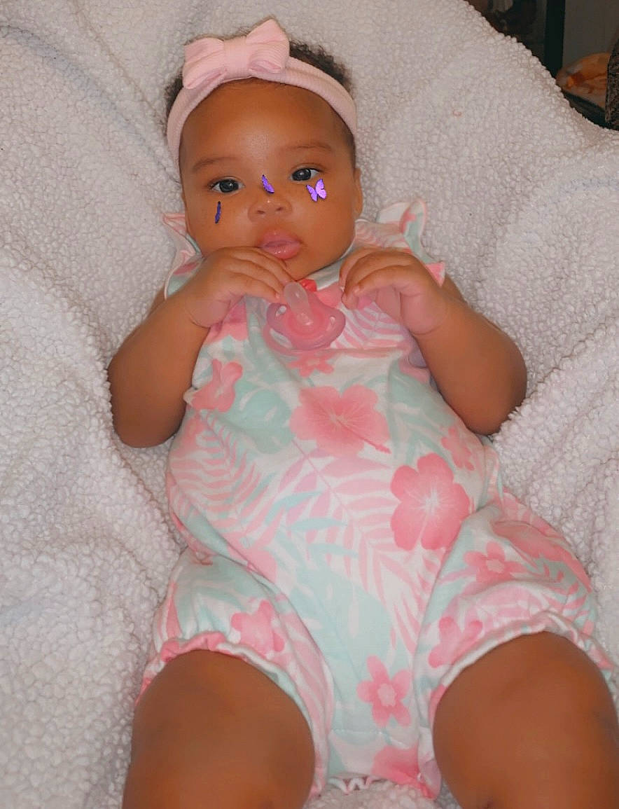 Serenity is registered to the contest to win money with this photo: baby, baby_toddler_clothing, cheek, chest, comfort, eye, finger, head, human_leg, knee, lip, mouth, nose, person, pink, skin, sleeve, stomach, thigh, toddler