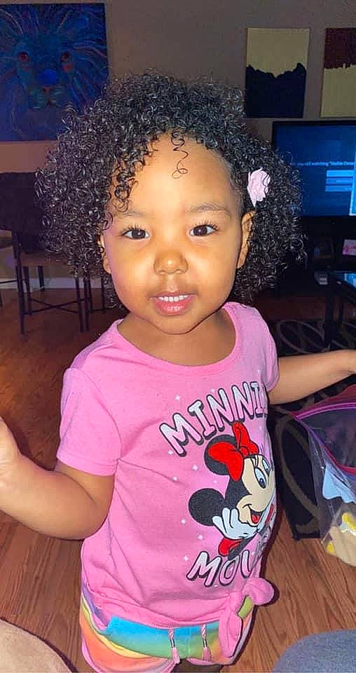 Zola is registered to the contest to win money with this photo: afro, baby_toddler_clothing, black, black_hair, cheek, cool, eyelash, facial_expression, hairstyle, happy, head, jheri_curl, nose, organ, person, pink, skin, sleeve, smile, t_shirt