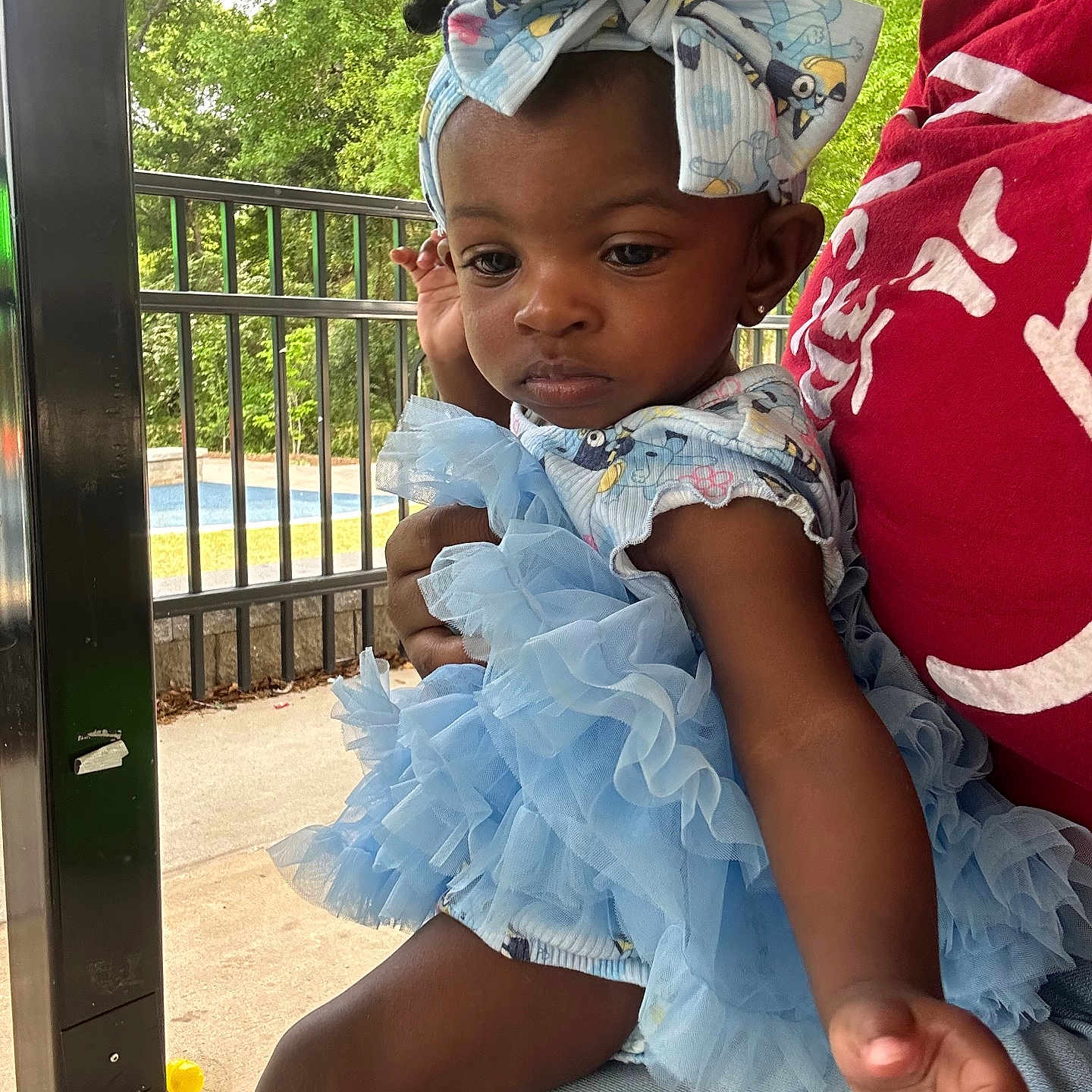 Zynaisjah joined the competition — help win amazing prizes! baby, blue_dress, casual, child, cute, daylight, expression, fashion, fence, hand, headband, outdoor, person, pool, portrait, red_shirt, sitting, toddler, trees, young_child