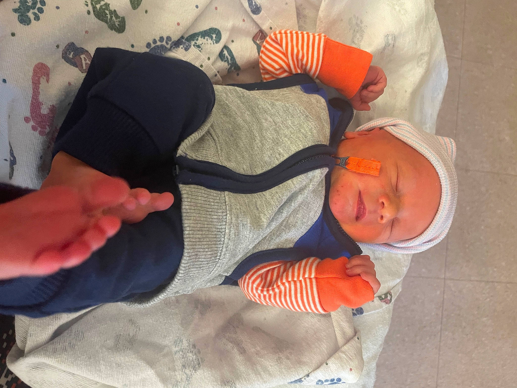 Zander is registered to the contest to win money with this photo: baby, baby_products, baby_toddler_clothing, child, comfort, elbow, finger, foot, gesture, head, headgear, human_leg, knee, lap, linens, person, sleeve, sock, thumb, toddler