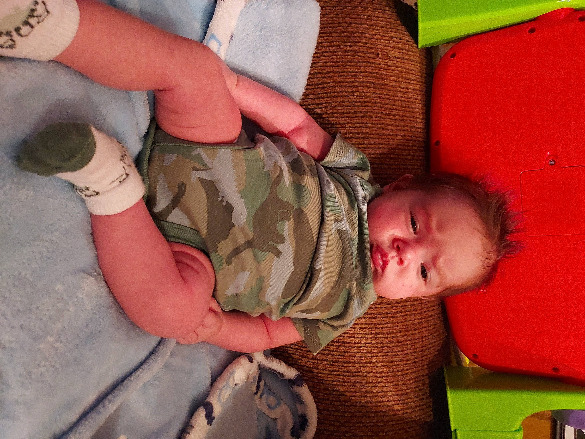 Layne is registered to the contest to win money with this photo: baby, camouflage, child, comfort, finger, gesture, human_body, joint, leg, marines, military_camouflage, military_person, military_uniform, pattern, person, skin, sleeve, soldier, thumb, toddler