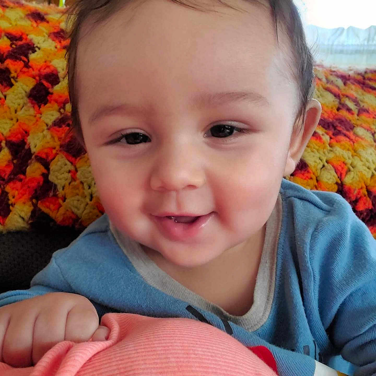 Luther joined the competition — help win amazing prizes! baby, blue_clothing, child, cozy, crocheted_blanket, cute, eyes, face, hair, hand, happy, head, indoor, person, pink_surface, portrait, skin, smile, warm_colors, young_child