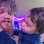 Luther joined the competition — help win amazing prizes! man, child, indoor, curly_hair, beard, toddler, purple_light, casual_clothing, face, portrait, closeup, person, interaction, family, home, smile, young_child, holding, affection