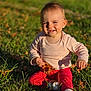 baby, child, grass, leaf, outdoor, smiling, sitting, sunlight, autumn, nature, toddler, happy, clothing, long_sleeve, pants, sock, cute, playing, fun, portrait