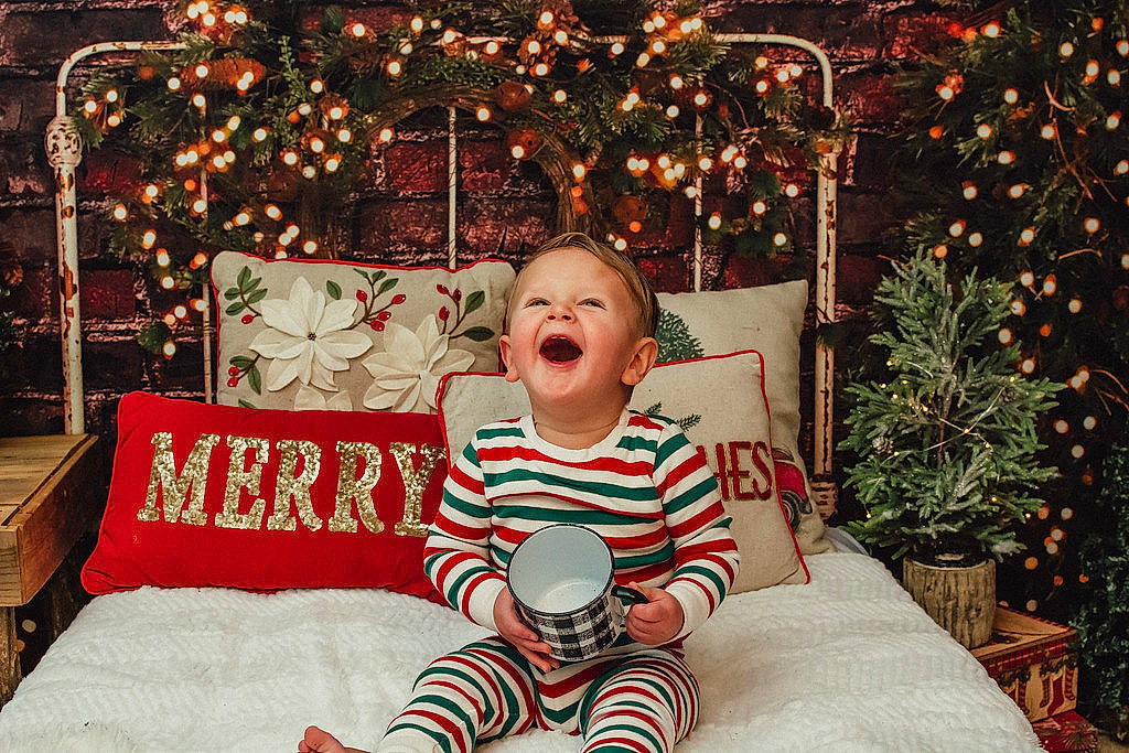 Dominick is registered to the contest to win money with this photo: baby, candy_cane, child, christmas, christmas_decoration, christmas_eve, christmas_lights, christmas_ornament, christmas_tree, event, facial_expression, furniture, happy, holiday, home, interior_design, person, room, sitting, toddler
