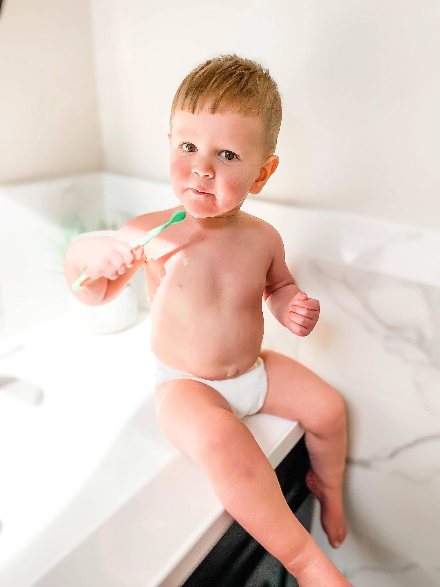 Dominick is registered to the contest to win money with this photo: baby, baby_bathing, bathing, bathtub, blond, child, diaper, leg, muscle, person, plumbing_fixture, room, sitting, skin, toddler