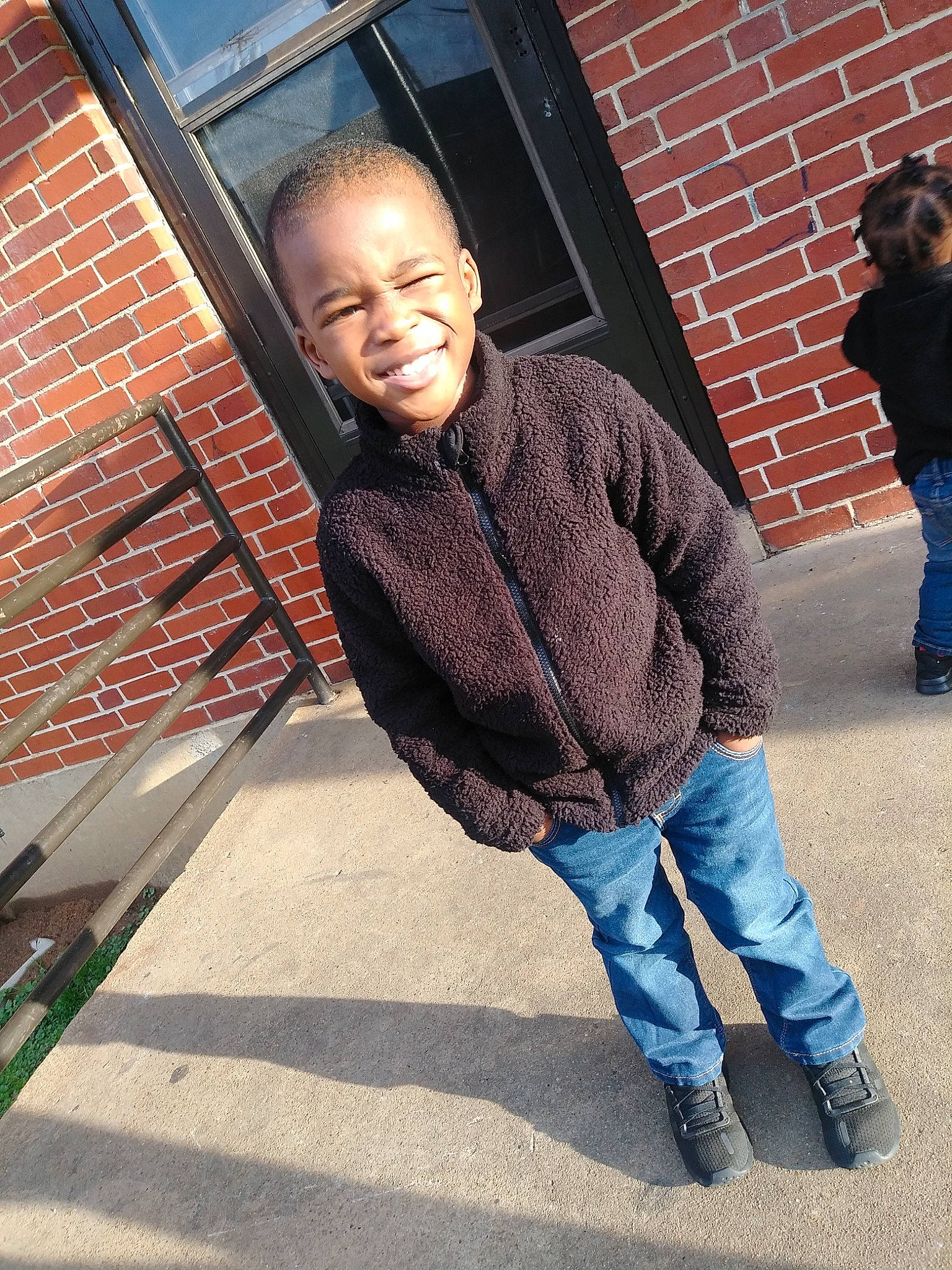 Kamarriun is registered to the contest to win money with this photo: architecture, cool, denim, human, jacket, jeans, joy, outerwear, person, photography, shoe, sitting, smile, snapshot, t_shirt, top