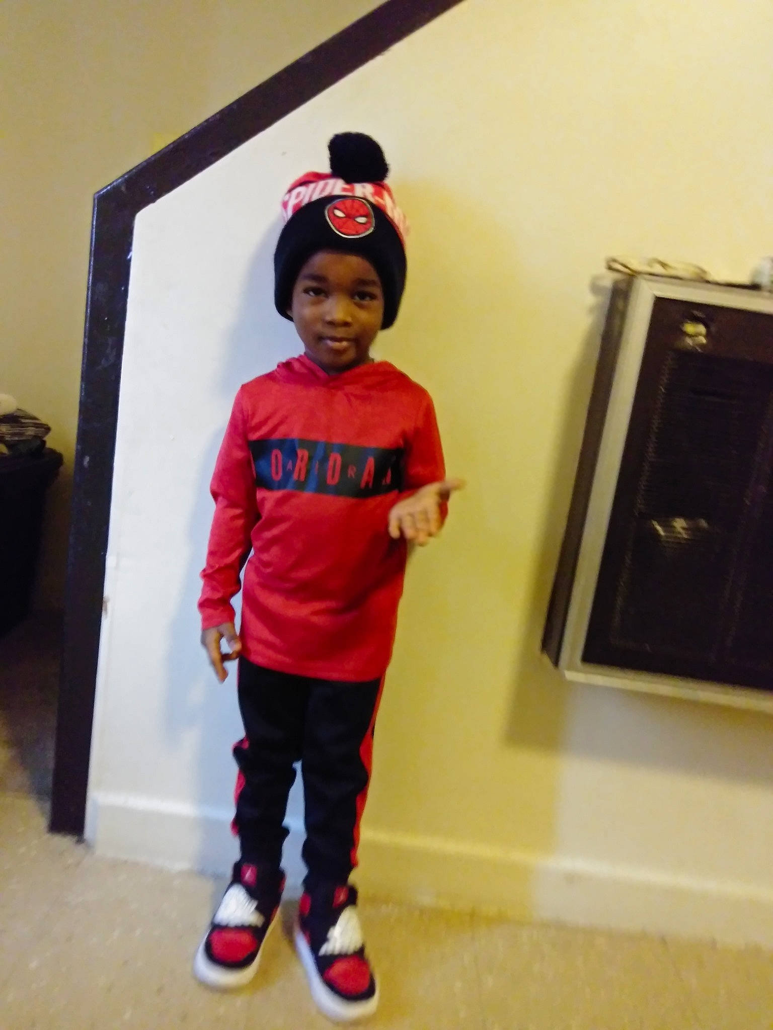 Kamarriun is registered to the contest to win money with this photo: child, cool, fun, headwear, person, pink, red, shoulder, standing, t_shirt